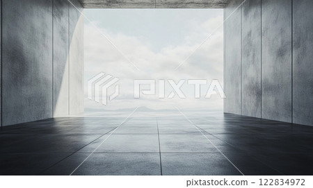 Large, empty room with a view of the ocean. The room is made of concrete and has a very modern feel 122834972