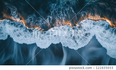 The ocean is calm and the waves are white. The water is a deep blue color. The sun is shining on the water, creating a beautiful and serene scene The ocean is calm and the waves are white. The water is a deep blue color. The sun is shining on the water, creating a beautiful and serene scene 122835033