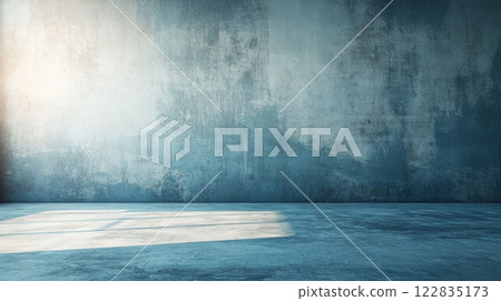 Large, empty room with a blue wall. The room is bare and empty, with no furniture or decorations. The blue wall is the only color in the room, giving it a monochromatic and minimalist feel 122835173