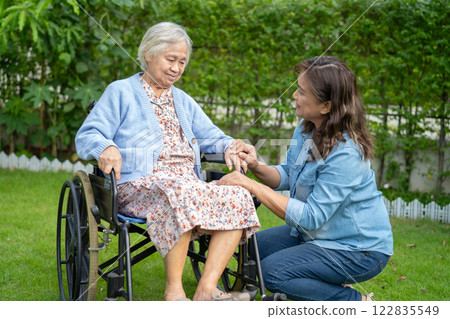 Caregiver help and care Asian senior woman patient sitting on wheelchair at nursing hospital ward, healthy strong medical. 122835549