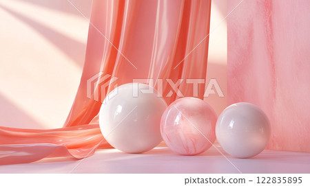 Pink curtain hangs in front of three white spheres. The spheres are of different sizes and are placed in a row. The scene has a soft and elegant feel, with the pink curtain 122835895