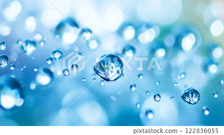 Close up of water droplets on a blue surface. The droplets are scattered throughout the image, creating a sense of movement and fluidity Close up of water droplets on a blue surface. The droplets are scattered throughout the image, creating a sense of movement and fluidity 122836055