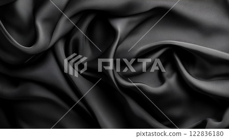 Black fabric with a pattern that is not visible. The fabric is long and has a smooth texture 122836180