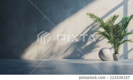 White vase with a plant in it sits in front of a wall. The plant casts a shadow on the wall, creating a sense of depth and dimension in the room White vase with a plant in it sits in front of a wall. The plant casts a shadow on the wall, creating a sense of depth and dimension in the room 122836187