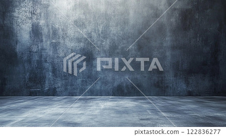 Large, empty room with a grey wall. The room is bare and empty, with no furniture or decorations. The grey wall gives the room a cold, sterile feel 122836277