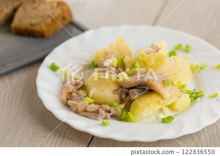 Potatoes and herring with green onions 122836550