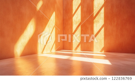 Room with a tan wall and a window that is letting in sunlight. The room is empty and has a very bright and warm atmosphere 122836769