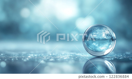 Clear sphere of water sits on a surface. The water is calm and still, reflecting the sky above. Concept of tranquility and serenity, as if the water is a symbol of peace and calmness Clear sphere of water sits on a surface. The water is calm and still, reflecting the sky above. Concept of tranquility and serenity, as if the water is a symbol of peace and calmness 122836884