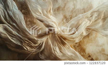 White fabric with a knot in the middle. The knot is in the center of the fabric and is surrounded by the fabric 122837120