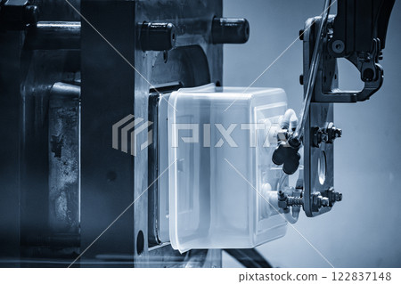 Close up scene material handling process the food container by robotic system from injection machine. 122837148