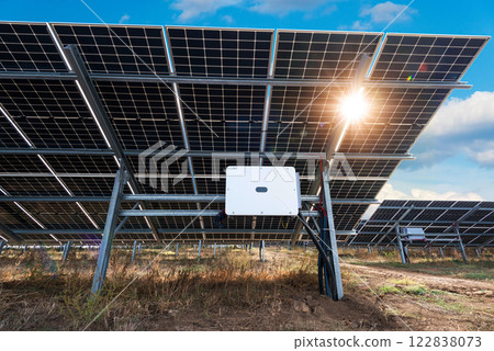 Photo collage of Bilateral solar panels, photovoltaics with sun reflection - alternative source of electricity, concept of sustainable and renewable resources. Panoramic view. 122838073
