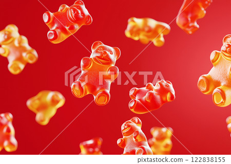 Red gummy bears floating in air on a vibrant red background. Gummy bear candies suspended in mid-air over bright backdrop. Sweets and happy childhood concept. 122838155