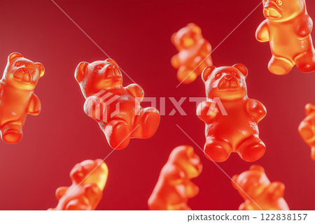 Red gummy bears floating in air on a vibrant red background. Gummy bear candies suspended in mid-air over bright backdrop. Sweets and happy childhood concept. Red gummy bears floating in air on a vibrant red background. Gummy bear candies suspended in mid-air over bright backdrop. Sweets and happy childhood concept. 122838157