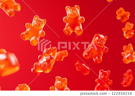 Red gummy bears floating in air on a vibrant red background. Gummy bear candies suspended in mid-air over bright backdrop. Sweets and happy childhood concept. Red gummy bears floating in air on a vibrant red background. Gummy bear candies suspended in mid-air over bright backdrop. Sweets and happy childhood concept. 122838158
