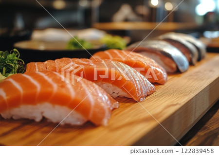 Freshly prepared sushi assortment displayed on a wooden platter in a bustling sushi restaurant 122839458