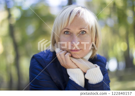 Forty year old woman in the park on the street. Portrait of middle age man 122840157