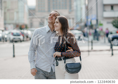 Two tourists having fun on romantic summer vacation in Poland - Holidays and traveling lifestyle concept. Young couple walking street on vacation. Happy couple of travelers enjoying. 122840630