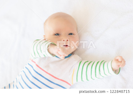Little baby on white bed 122840715