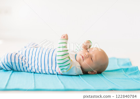 Little baby on white bed 122840784