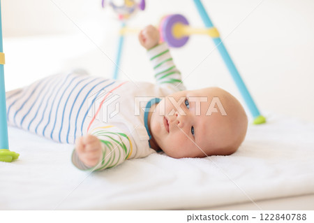 Little baby on white bed 122840788