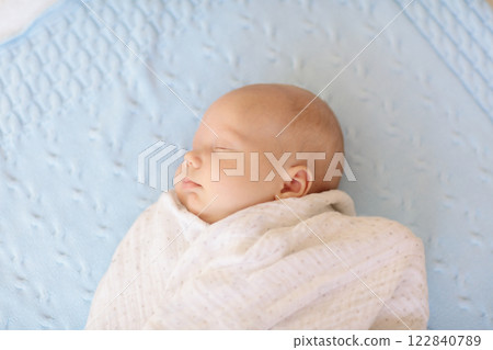 Little baby on white bed 122840789