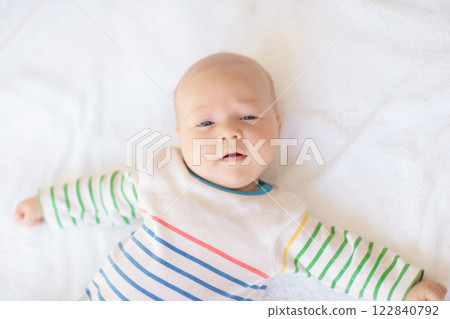 Little baby on white bed 122840792