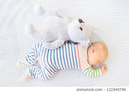 Little baby on white bed 122840796