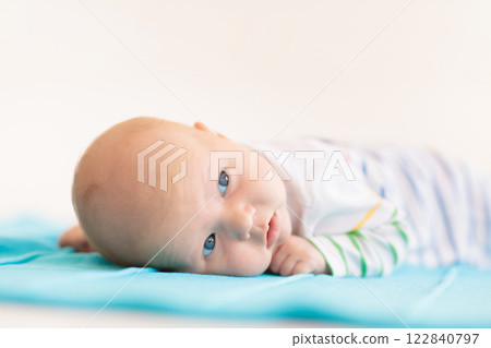 Little baby on white bed 122840797
