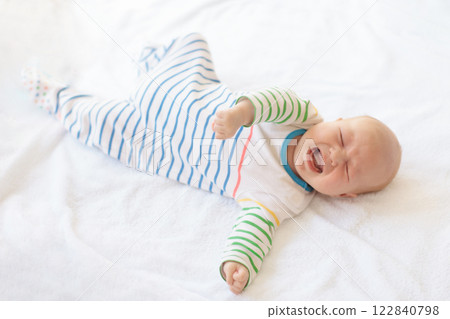 Little baby on white bed 122840798