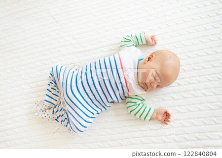 Little baby on white bed 122840804