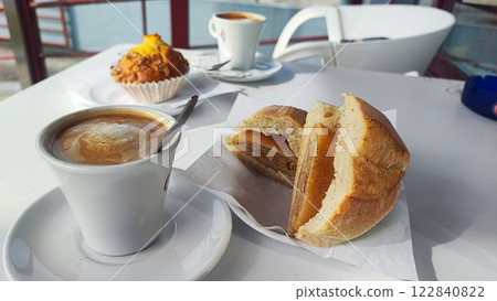 Traditional breakfast in Portugal - coffee, bun, rice on the terrace in the morning. Tourism concept, world cuisine traditions 122840822