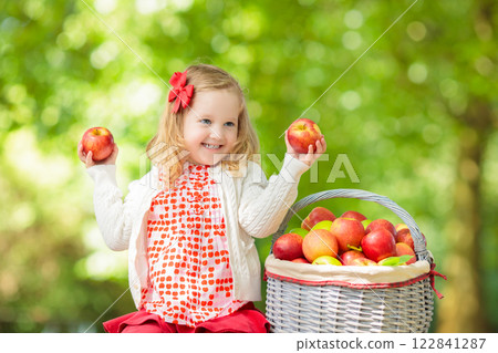 Kids picking apples on fruit farm 122841287