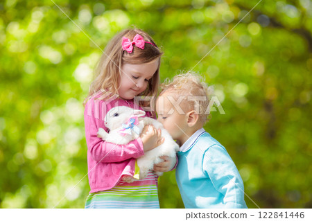 Little girl playing with rabbit 122841446