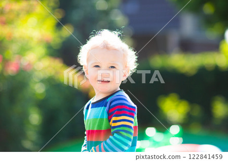 Baby boy in summer garden 122841459