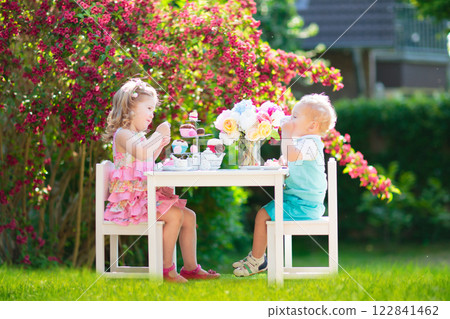 Kids having fun at garden tea party 122841462