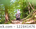 Father with children in all terrain stroller 122841476