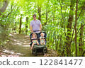 Father with children in all terrain stroller 122841477