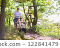 Father with children in all terrain stroller 122841479