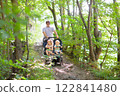 Father with children in all terrain stroller 122841480