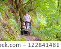 Father with children in all terrain stroller 122841481