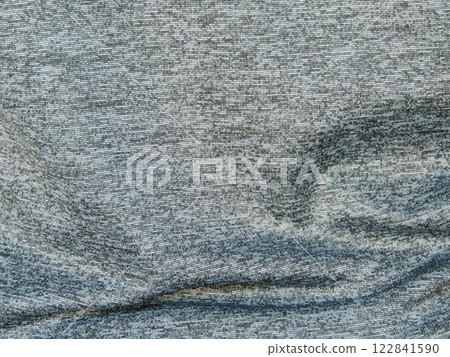 grey variegated fabric with wavy crumpled surface as drapery background or canvas texture, synthetic silver material with short line pattern grey variegated fabric with wavy crumpled surface as drapery background or canvas texture, synthetic silver material with short line pattern 122841590