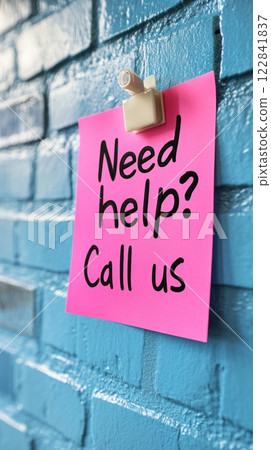 Pastel Pink Sticky Note With Need Help Call Us Written, On Blue Brick Wall With Copyspace. Pastel Pink Sticky Note With Need Help Call Us Written, On Blue Brick Wall With Copyspace. 122841837