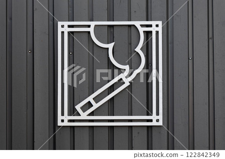 White smoking area sign on dark grey fence. White smoking area sign on dark grey fence. 122842349