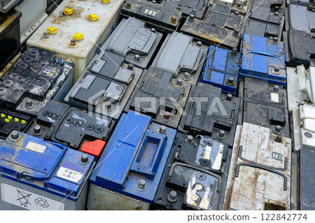 Stack of many used car batteries for recycling in a hazardous waste facility Stack of many used car batteries for recycling in a hazardous waste facility 122842774