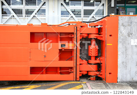 Hydraulic Hinge of big red gate at port, steel gate for Water retention and port traffic. 122843149