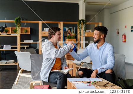 Young man with Down syndrome greeting his special educator teacher. 122843178