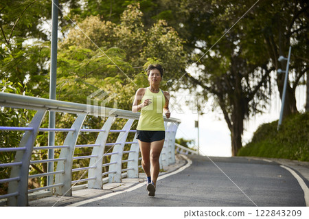 young asian woman running jogging outdoors young asian woman running jogging outdoors 122843209