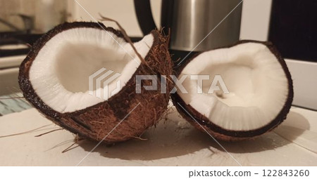 Freshly Cracked Coconut on a Kitchen Counter Freshly Cracked Coconut on a Kitchen Counter 122843260