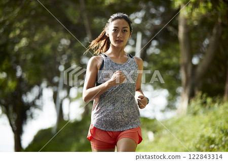young asian woman jogging running in park young asian woman jogging running in park 122843314