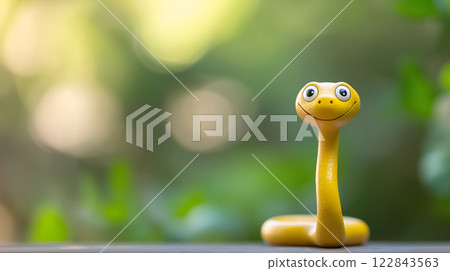 Cute smiling cartoon snake on nature background with copy space 122843563